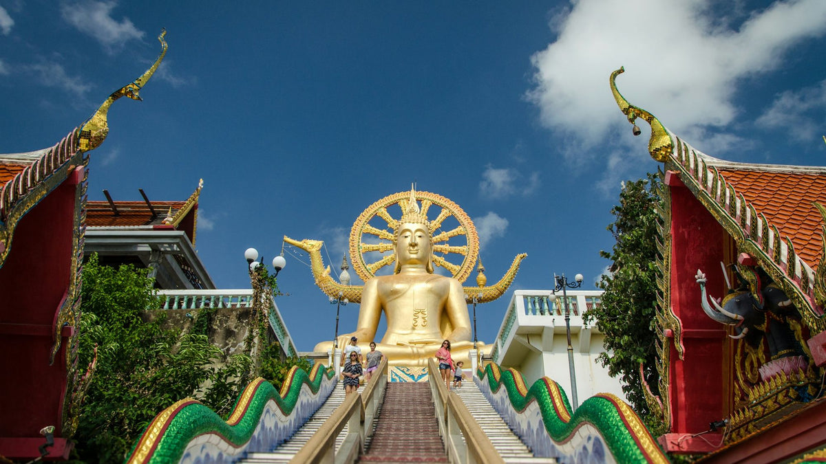 The golden Big Buddha statue at Wat Phra Yai in Bangrak, Koh Samui, with its naga staircase