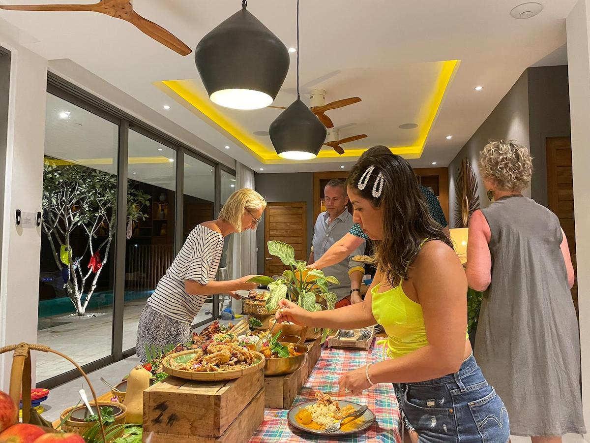 Friends and family getting food during their private chef experience.