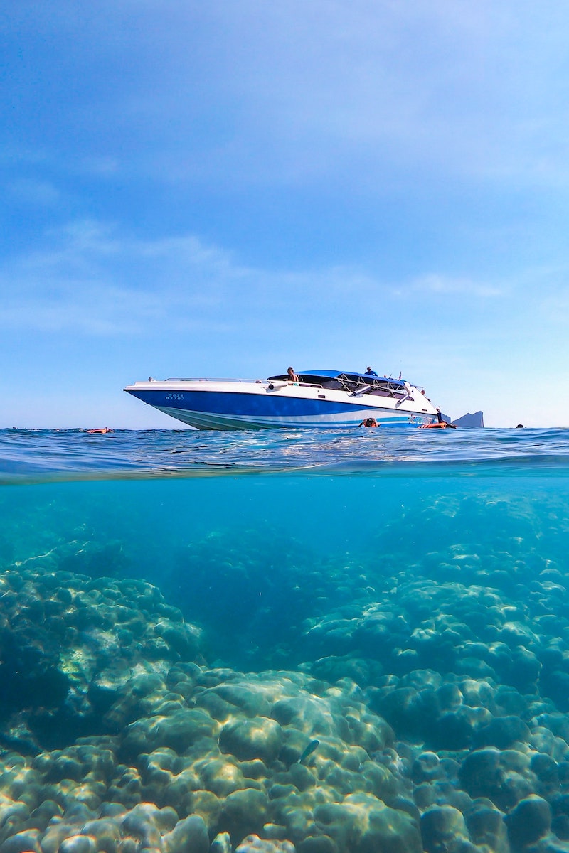 Speedboat in Koh Tao, Thailand, with snorkellers enjoying the vibrant marine life in the water.