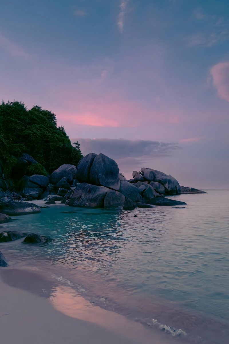 Granite boulders along a quiet stretch of Koh Samui's coastline at dusk