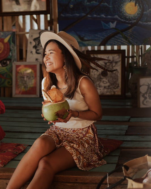 Lady laughing with coconut in Thailand 