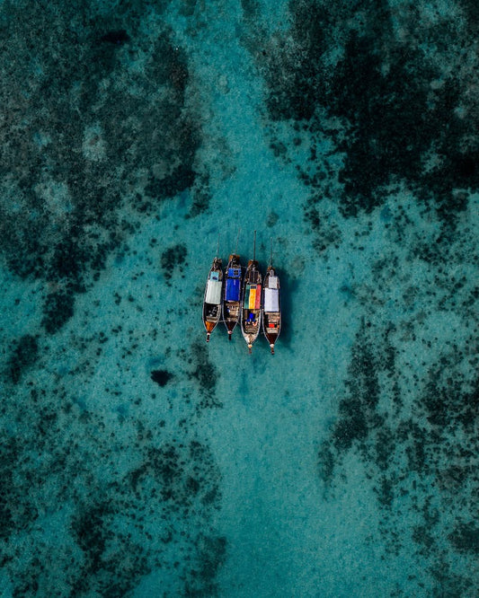 Four boats floating in the waters of Koh Samui, Thailand