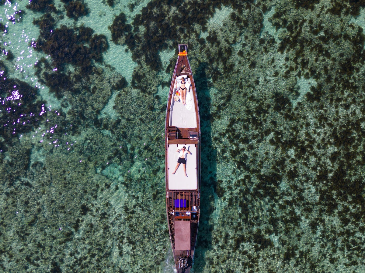 An aerial view of luxury longtail boat in Koh Mad Sum (Pig Island) and Koh Taen