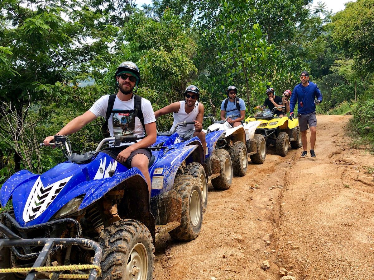 Group of friends having fun on quad biking tour