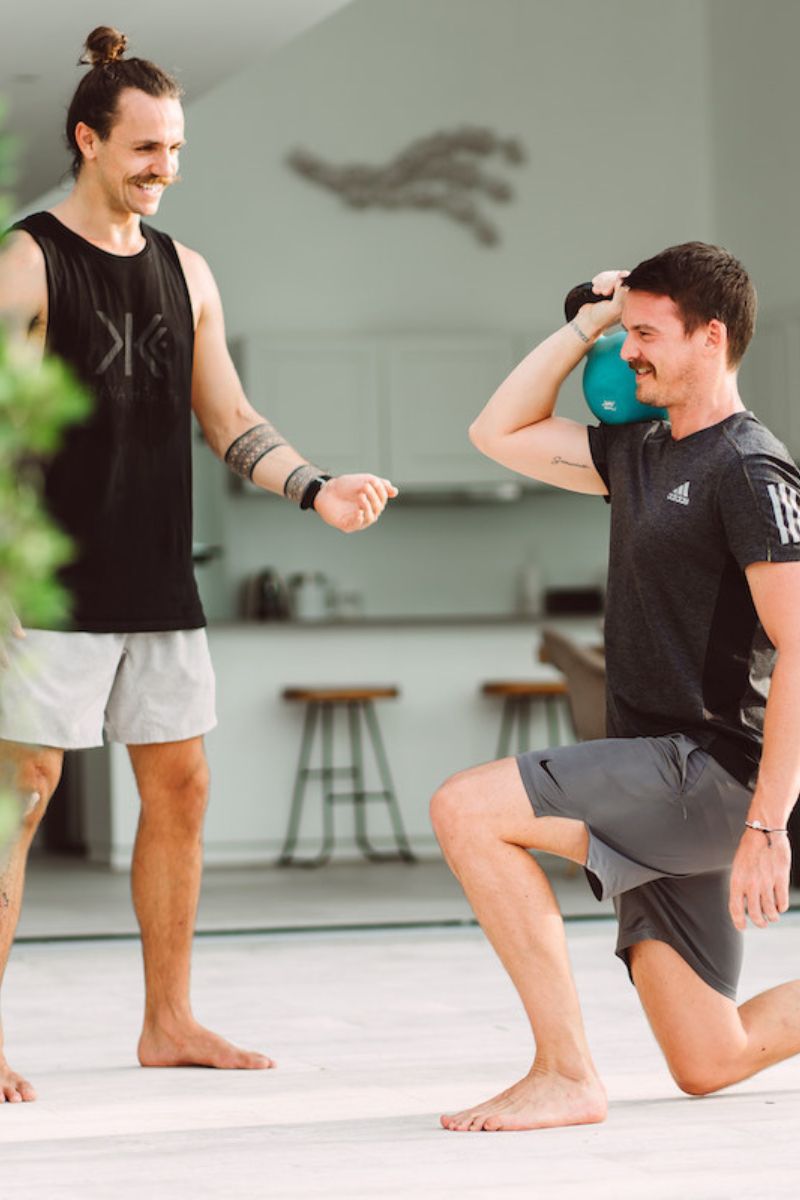 Two men exercising together in a home setting