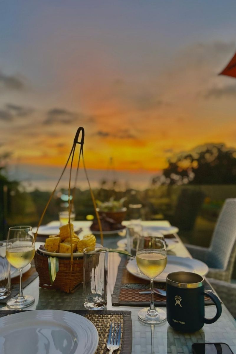Dining table set for a meal with sunset in the background