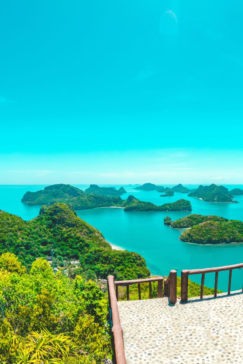 Scenic view of a tropical island archipelago with clear blue water and greenery.