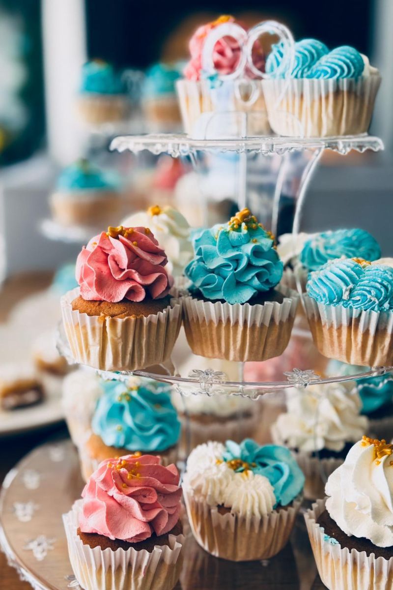 Decorative cupcakes with colorful frosting on a tiered stand.