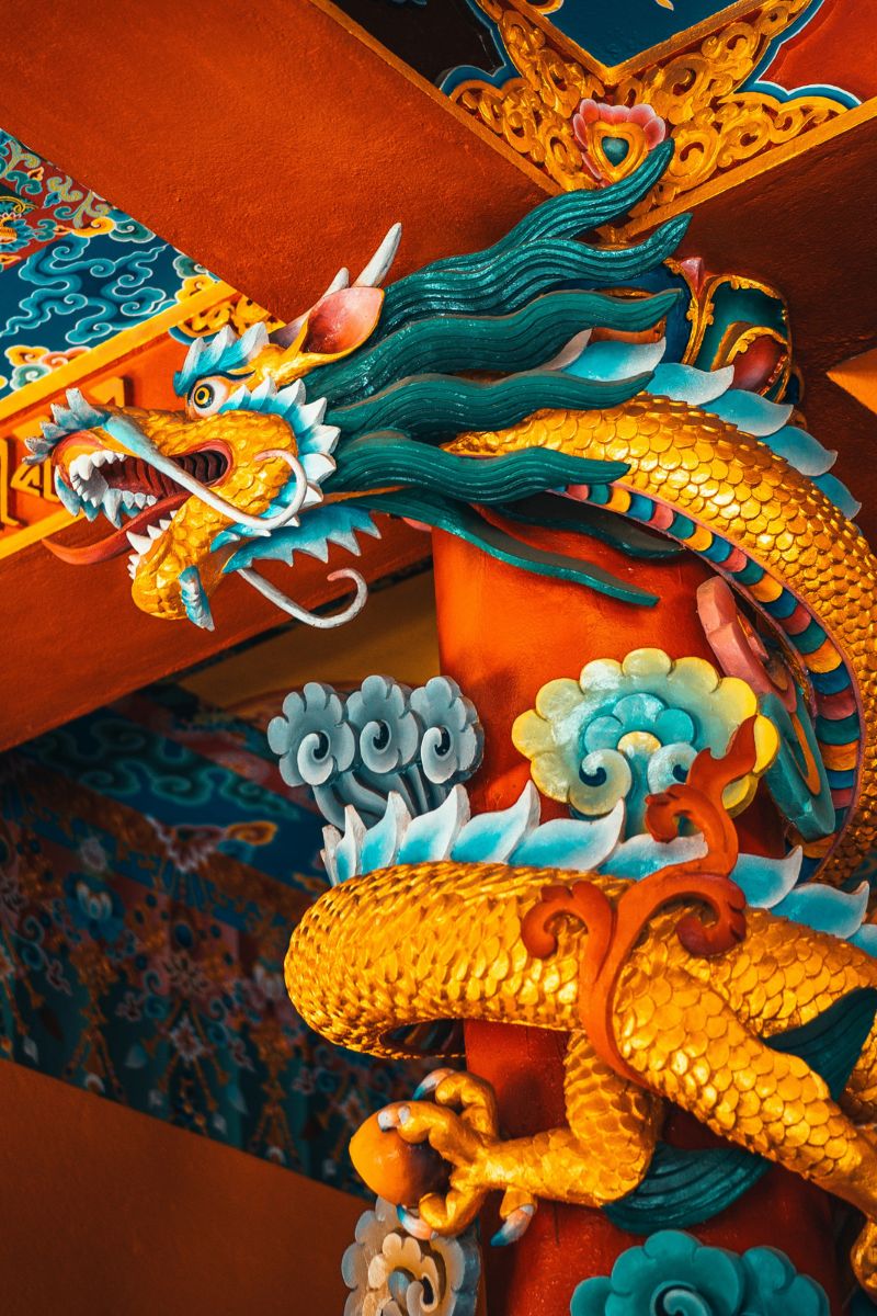 Colorful dragon sculpture on a wall with intricate details