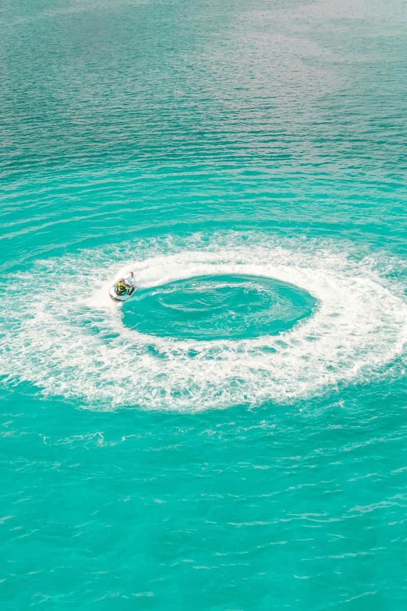 Turquoise water with a circular whirlpool effect