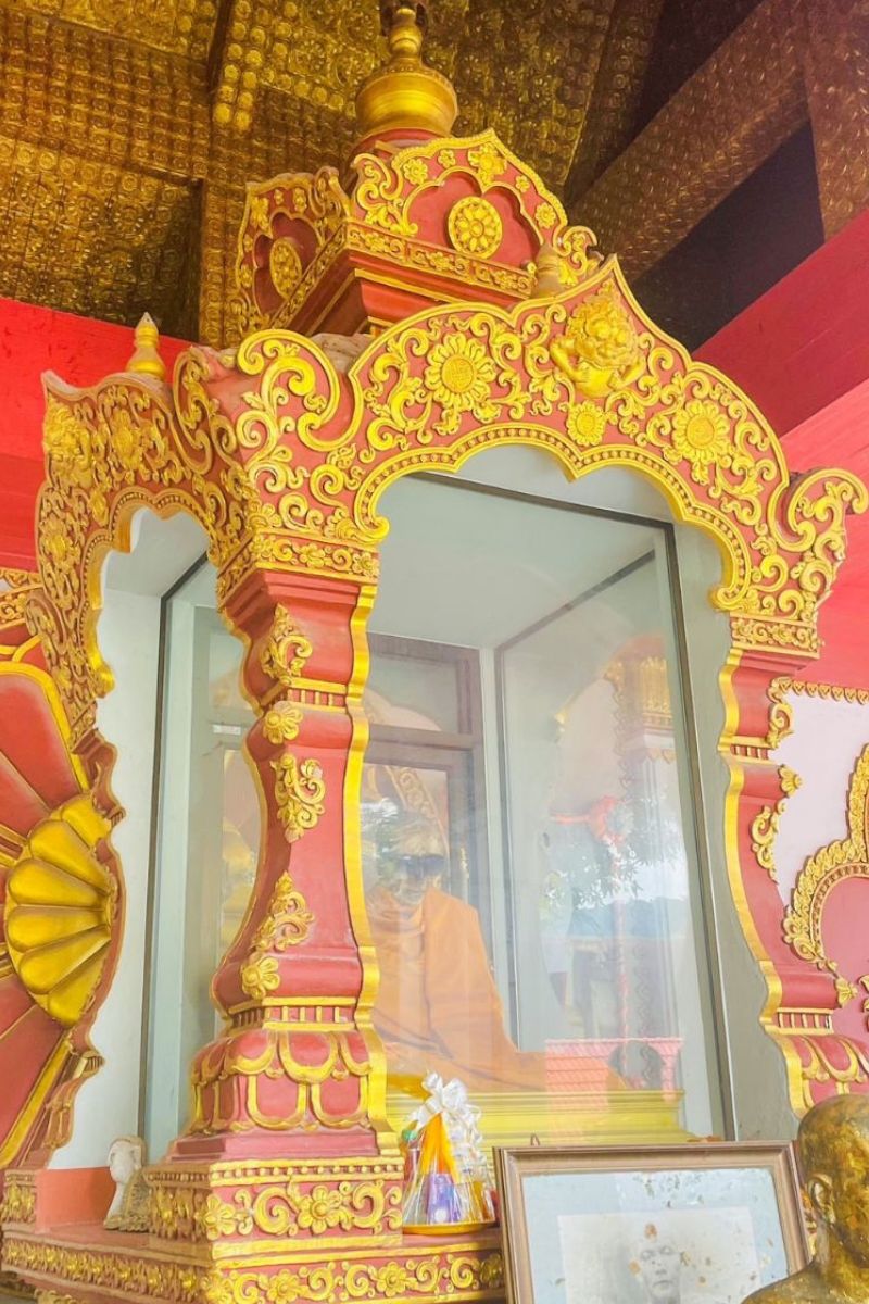 Decorative shrine with gold and red elements in a religious setting